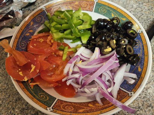 All the toppings taken out and placed in a bowl.