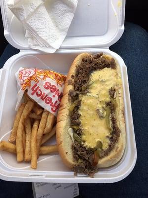 Large Cheesesteak with honey mustard and a lard side of fries.