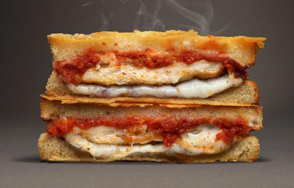 Chicken Parmesan - Provolone, mozzarella, roasted chicken tenders, Rustica sauce, savory spices, and a parmesan crust.