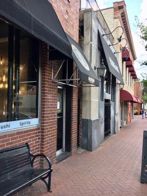 Outside of restaurant on N Main - door has black awning with skull drawing sandwiched between Poor Billy's and Boudreaux's