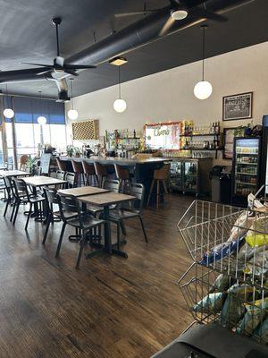 More seating and cute bar area! The lighting was actually dimmer and cozier than photographed