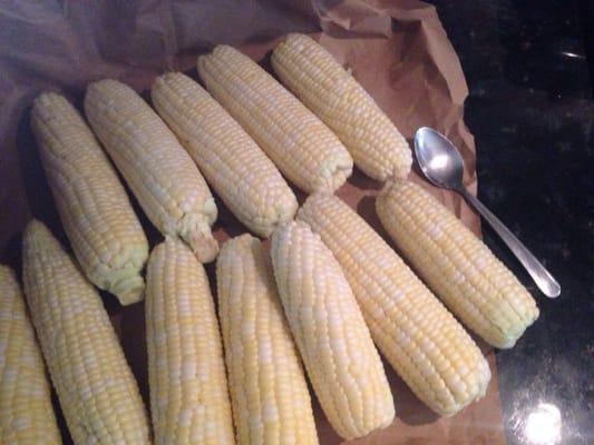 teaspoon next to shucked corn