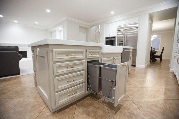 Kitchen refinish with custom trash can pullouts, farm sink setting, lighting features and elegant Brizo plumbing fixtures