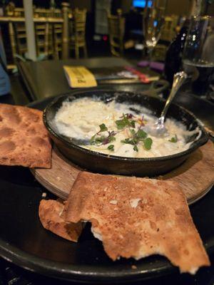 Goat cheese dip with a honey drizzle and almond slivers