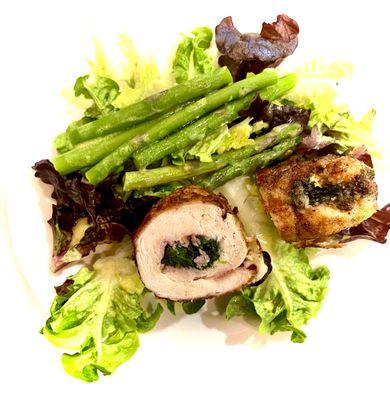 "Chicken Paupiette" (rolled and stuffed chicken breast) with spring asparagus and garden lettuce.