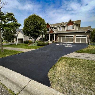 Finished repaired driveway with infrared repair and sealcoating.