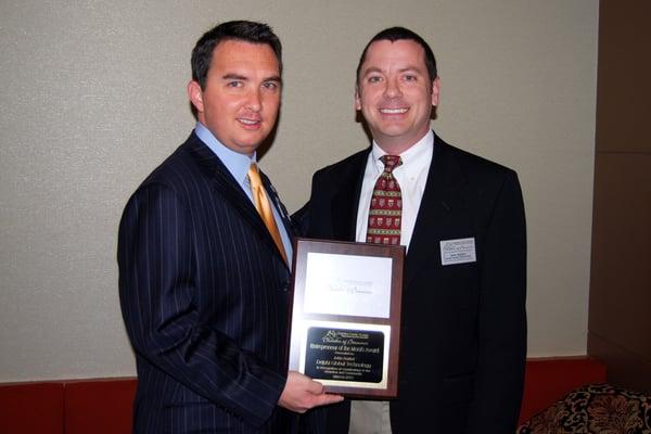 John receiving the Entrepeneur of the Month award from the Cherokee Chamber of Commerce