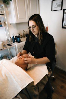 Dorthy performing a custom facial