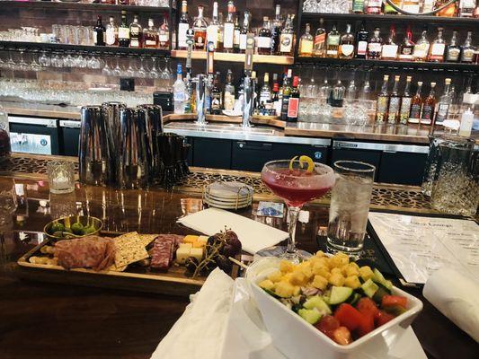 Charcuterie board and a side salad. The drink is the hibiscus lemon drop.