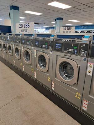 Signage above wash machines to choose from according to your need. Machines are operated with either coins or credit cards