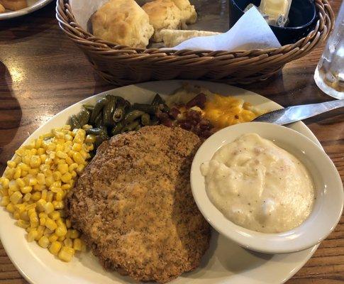 Country fried steak, side gravy and biscuits