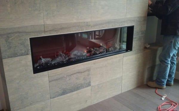 Electric fireplace being installed and making sure working properly