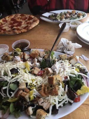 House salad with chicken, and wife's pizza.