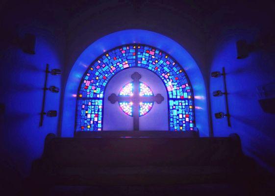 Stained glass window in the back of the choir loft