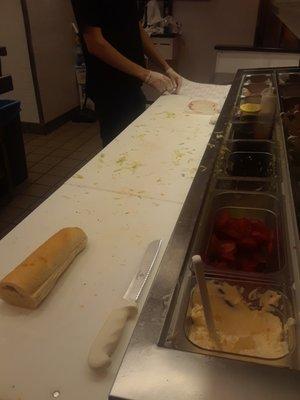 counter had fluids all over it, debris, dirty and notice sandwich bread sitting right in the middle with nothing under it