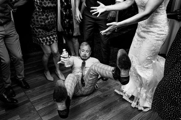 A guest falls while dancing at a lakeside Maine wedding. Photo by Kate Crabtree Photography.