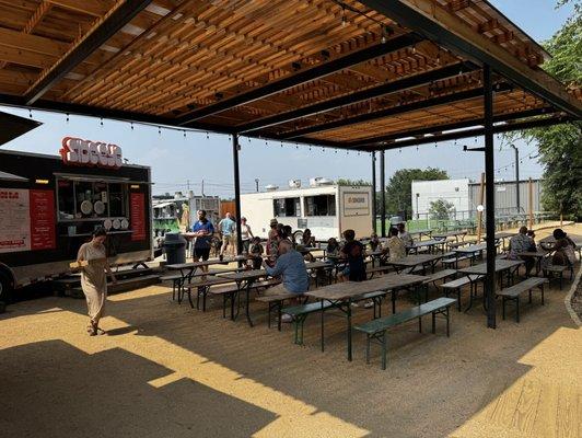 Outdoor seating by food trucks