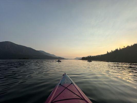 Kayaking towards sunset on the river