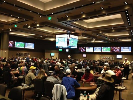 A fantastic card room with 15 huge 100" TVs and a central arena scoreboard!