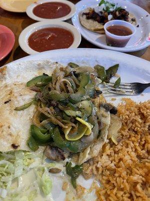 Veggie Burrito opened up to show the ingredients, No spinach, mostly onion & green pepper.