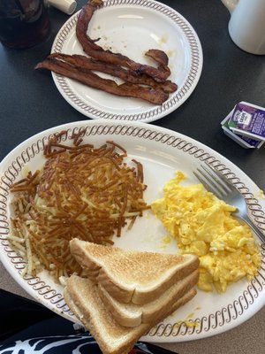 Scrambled eggs with cheese, toast, hash browns & toast with bacon