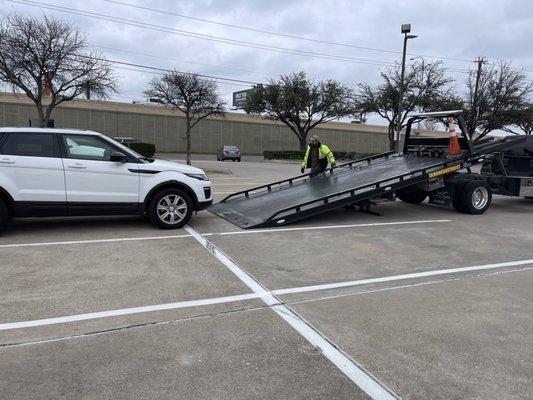 Tow truck company loading car