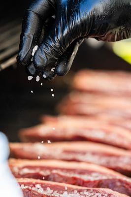 Picanha steak being seasoned