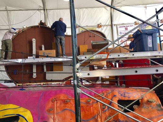 Volunteers gluing the ironed bark onto the guitar!