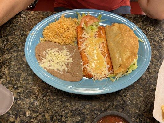 Cheese enchilada and chicken taco with rice and beans