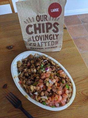 Double chicken, extra rice, tomatoes, fajita veggies, black beans. Plus large chips.