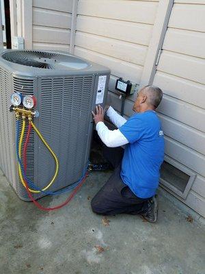 technician checking freon level on new install ac