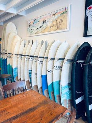 Nice quiver of fun boards for rent. Most under 6' I believe. The black ones are foamies.