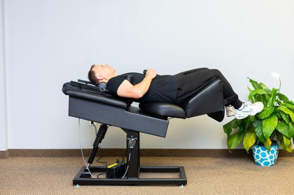 Patient receiving gentle low back traction on our new Back On Trac chair.