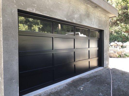 C.H.I. ALUMINUM GARAGE DOOR WITH LONG PANEL INSULATED GLASS TOP SECTION.