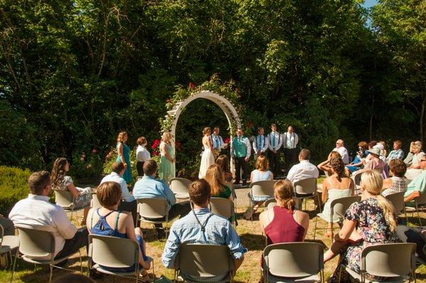 Ceremony around the rose arbor