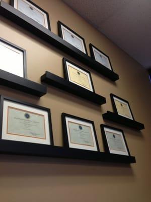 Wall of certificates in the waiting room.