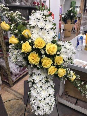 Beautiful cross white with yellow roses, great sympathy arrangement.