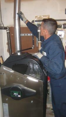 Technician working on a commercial hydronic boiler