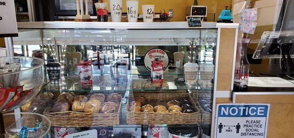 Bagels & Muffins! To the left is a 3 tier stand of fruit snacks, cookies & more, perfect for a quick grab & go!