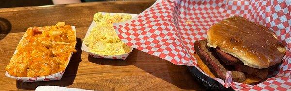 Mac and cheese, potato salad, and sliced brisket sandwich