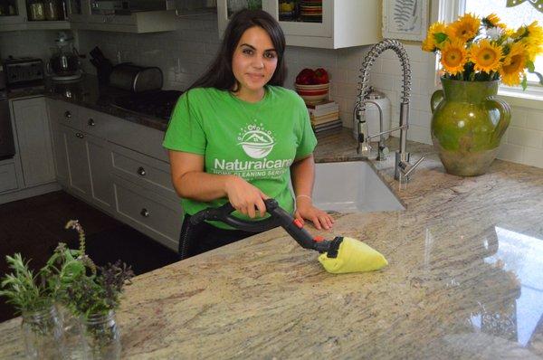 Lindsey, steam cleaning a counter.