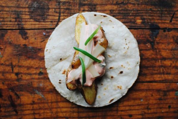 Fried Yukon Gold Potatoes with a chipotle sour cream, burnt scallion and 1 year aged cheddar