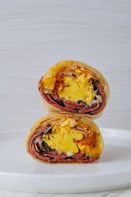 Pastrami Breakfast Burrito. Pasture Raised Eggs, Pastrami, Swiss Cheese, Fingerling Potatoes, Horseradish Aioli on Flour Tortilla.