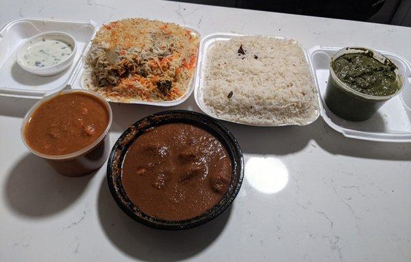 (left to right then bottom) yogurt, chicken biryani, rice, saag paneer, chicken vindaloo and lamb Rogan josh