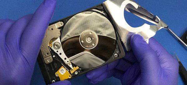 Disassembled hard disk drive (HDD) in Data Savers LLC's on-site cleanroom