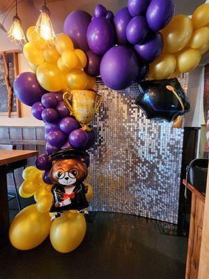 Graduation Foil Balloons on a Balloon Garland & Shimmer Wall.