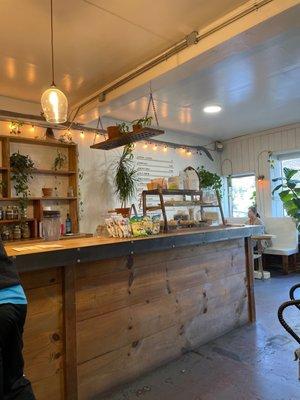 Coffee counter with pastries and the menu in the back.