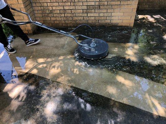 Cleaning years of grime from a patio.