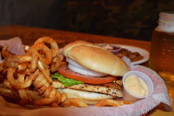 Grilled Mahi Sandwich: A taste of paradise on a bun! Paired perfectly with crispy curly fries, zesty aioli, and a squeeze of lemon