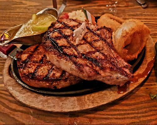 Grilled French loin pork chops with Irish whiskey glaze and homemade granny smith sauce, deep fried onion rings, baked ricotta tomato!